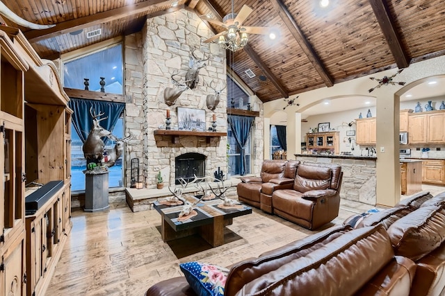 living room featuring beam ceiling, light hardwood / wood-style flooring, wood ceiling, and high vaulted ceiling