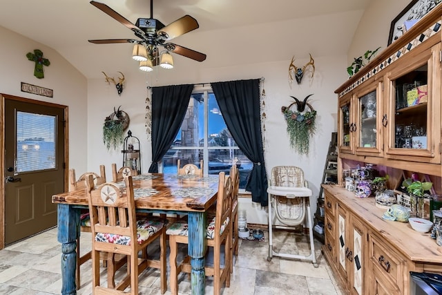 dining room featuring ceiling fan and vaulted ceiling