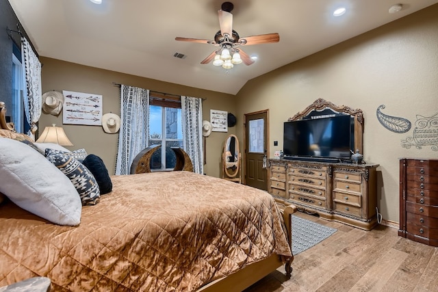 bedroom with lofted ceiling, hardwood / wood-style floors, and ceiling fan