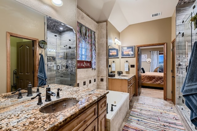 bathroom featuring vanity, lofted ceiling, and plus walk in shower