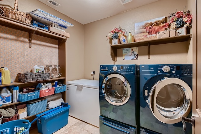 washroom with washing machine and dryer and light tile patterned floors