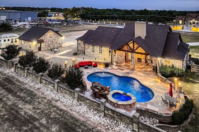 view of pool featuring an in ground hot tub and a patio