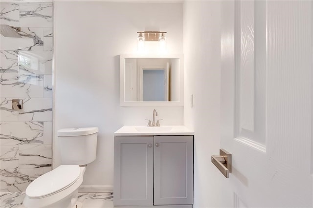 bathroom featuring vanity, toilet, and a tile shower