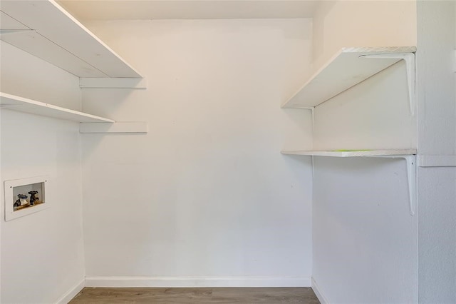 laundry room featuring washer hookup and wood-type flooring