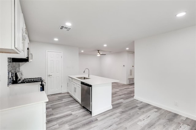 kitchen featuring sink, dishwasher, white cabinets, and light hardwood / wood-style flooring