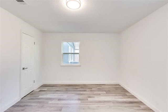 empty room with light hardwood / wood-style floors