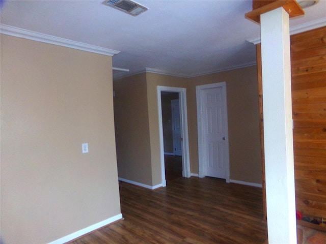 empty room featuring crown molding and dark hardwood / wood-style flooring