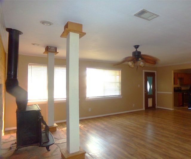 unfurnished living room featuring crown molding, wood-type flooring, and ceiling fan