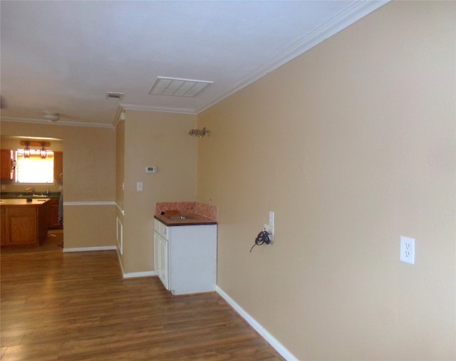 hall featuring ornamental molding and hardwood / wood-style flooring