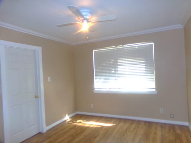 spare room featuring crown molding, wood-type flooring, and ceiling fan