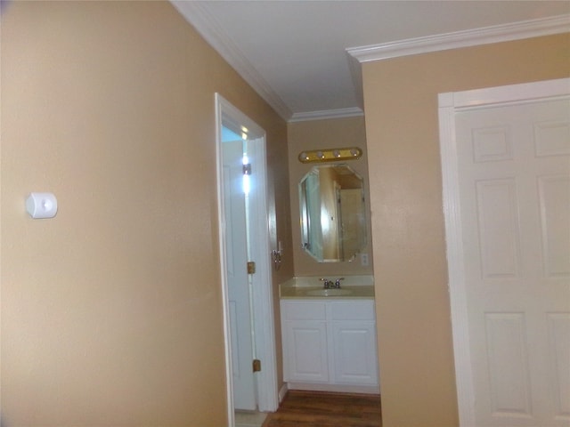 hallway with crown molding, sink, and dark hardwood / wood-style flooring