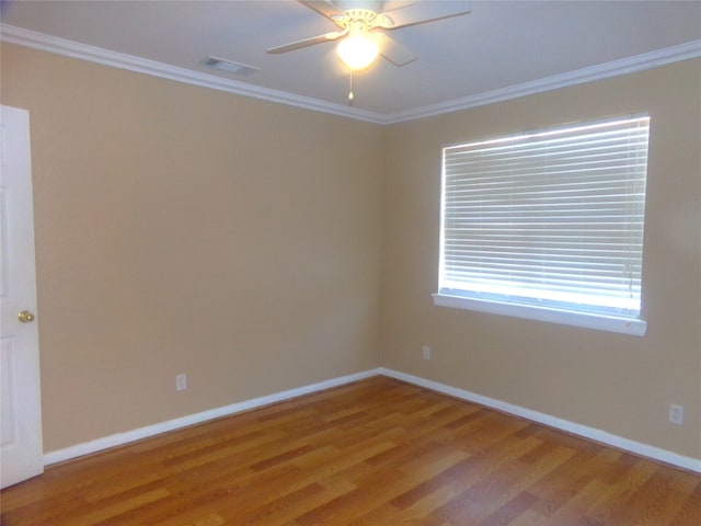 spare room featuring crown molding, hardwood / wood-style flooring, and ceiling fan