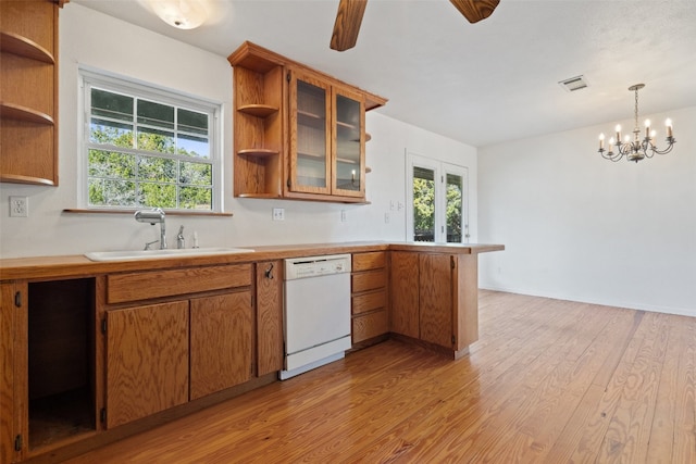 kitchen with sink, ceiling fan with notable chandelier, white dishwasher, hanging light fixtures, and light hardwood / wood-style floors