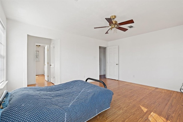 1401 Pursley Rd, Dripping Springs, TX 78620 - bedroom with baseboards, visible vents, wood finished floors, and a ceiling fan