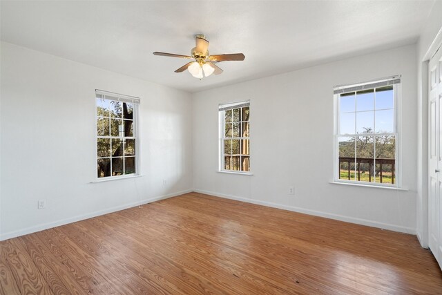 spare room featuring ceiling fan and hardwood / wood-style floors