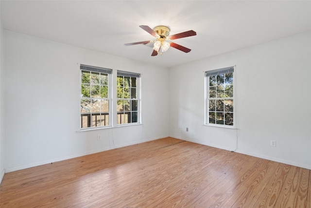 unfurnished room with light hardwood / wood-style floors, a healthy amount of sunlight, and ceiling fan