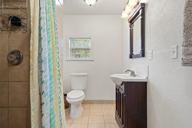 bathroom with vanity, walk in shower, toilet, and tile patterned floors