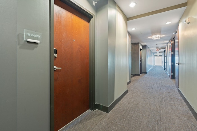 corridor featuring baseboards, carpet flooring, and recessed lighting