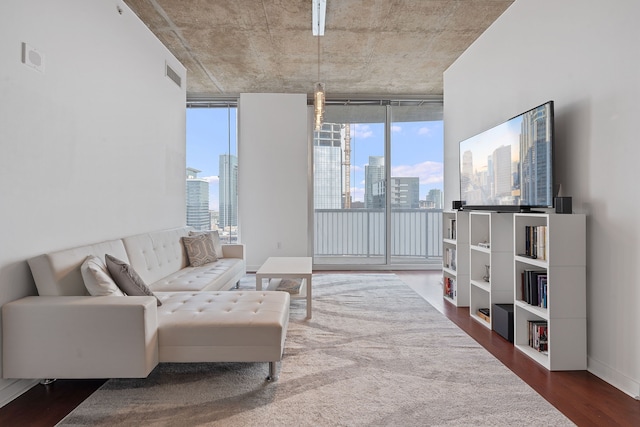 living area with visible vents, a wall of windows, and dark wood-style flooring