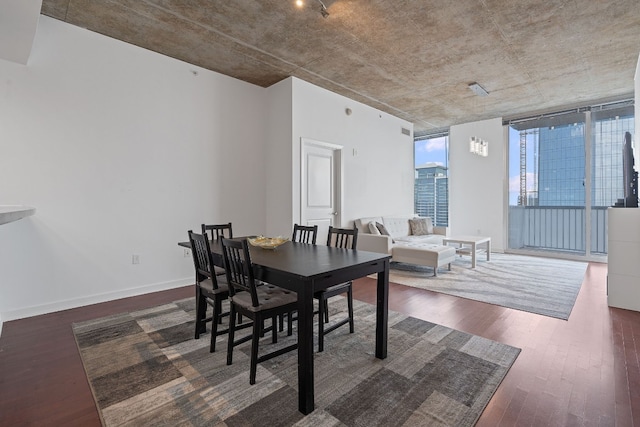 dining area featuring floor to ceiling windows and dark hardwood / wood-style floors