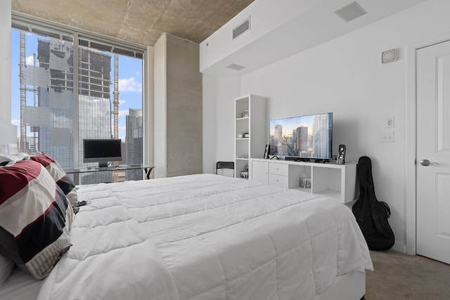 carpeted bedroom featuring visible vents