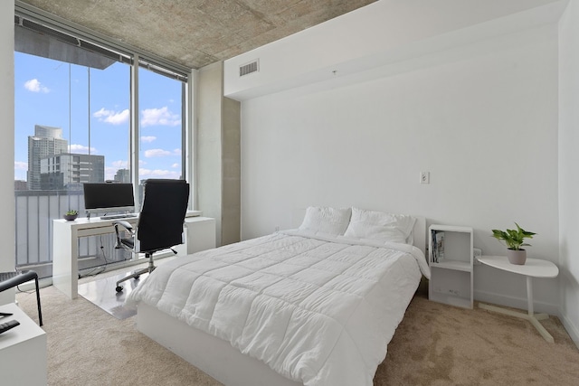 carpeted bedroom featuring a wall of windows and visible vents