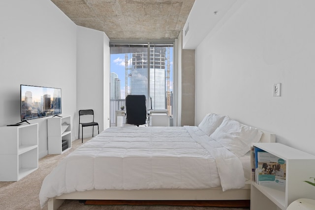 bedroom featuring light colored carpet and expansive windows