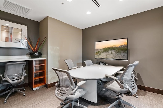 office space with carpet flooring, visible vents, and baseboards