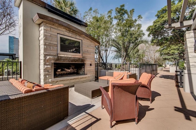 view of patio / terrace with an outdoor living space with a fireplace