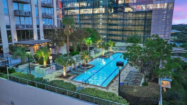 view of home's community with a pool, fence, and a patio