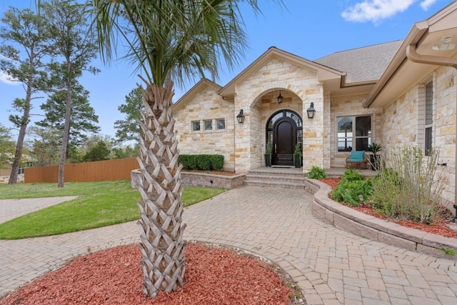 view of exterior entry featuring a yard