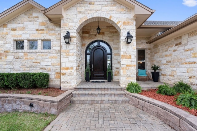property entrance with stone siding