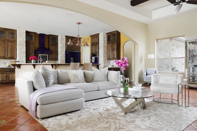 living room featuring ceiling fan, sink, and light tile patterned floors