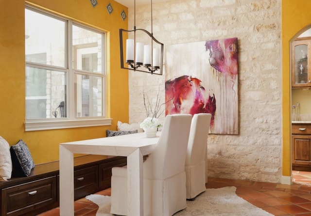 dining space featuring an inviting chandelier and light tile patterned floors