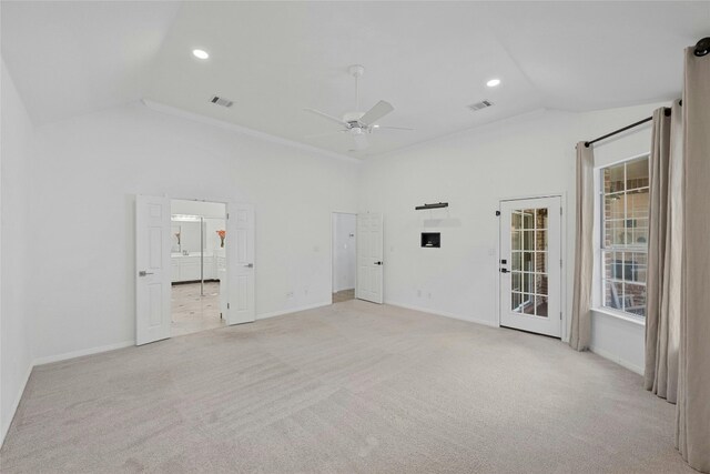 carpeted spare room featuring ceiling fan and vaulted ceiling