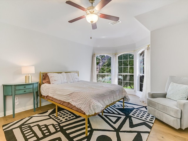 bedroom with light hardwood / wood-style floors and ceiling fan