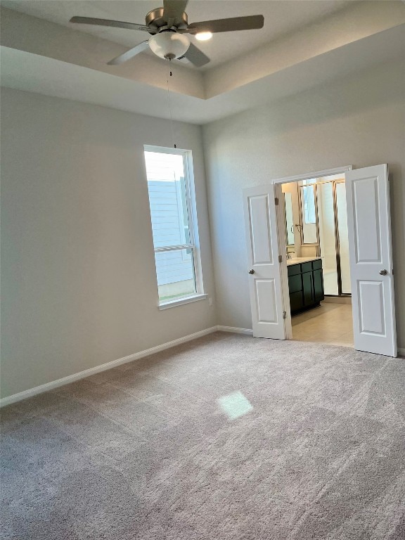 unfurnished room with light colored carpet and ceiling fan