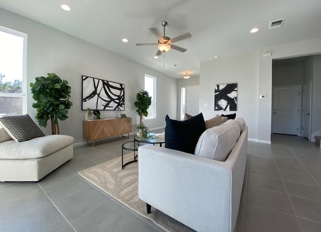 tiled living room featuring ceiling fan and a healthy amount of sunlight