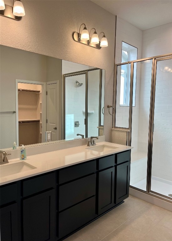 bathroom with tile patterned flooring, vanity, and an enclosed shower