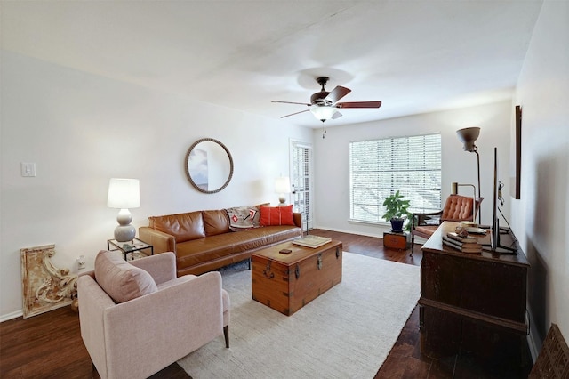 living room featuring ceiling fan and dark hardwood / wood-style floors