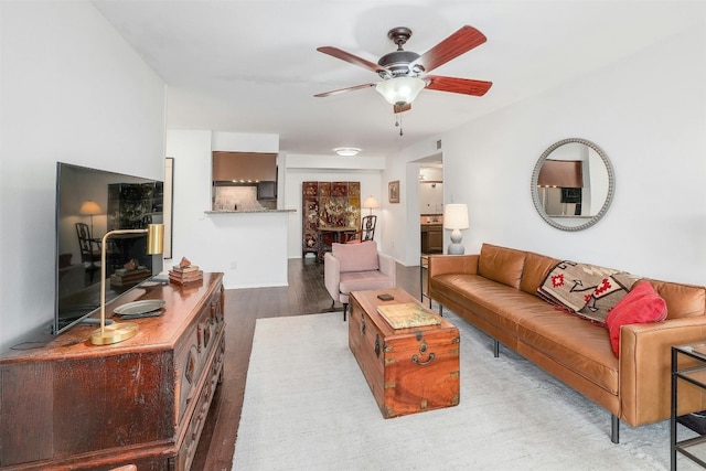 living room featuring ceiling fan and light wood-type flooring