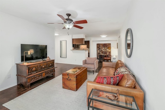 living room featuring ceiling fan and hardwood / wood-style flooring