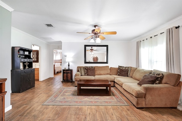 living room featuring crown molding, hardwood / wood-style flooring, and ceiling fan