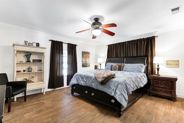 bedroom featuring crown molding, wood-type flooring, and ceiling fan