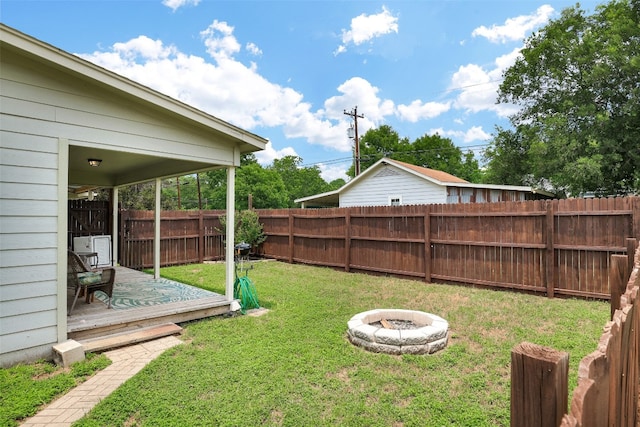 view of yard featuring a deck and a fire pit