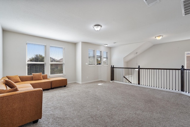 living area with a wealth of natural light and carpet flooring