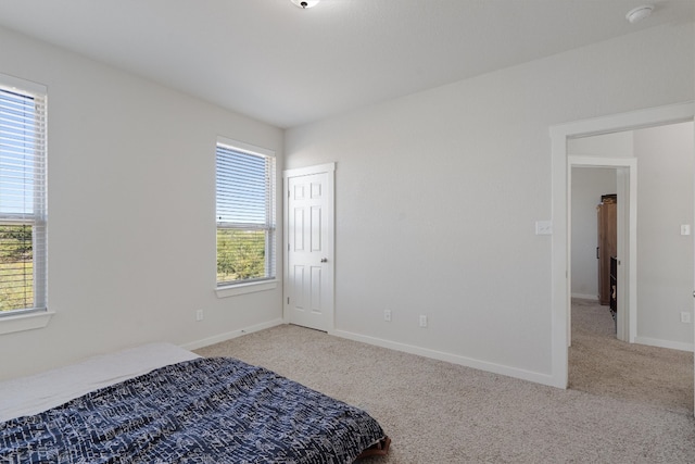 bedroom featuring light carpet