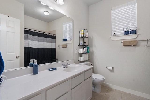 bathroom with vanity, toilet, and tile patterned flooring