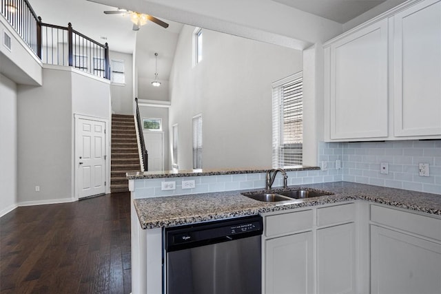 16304 Travesia Way, Austin, TX 78728 - kitchen featuring stainless steel dishwasher, ceiling fan, dark stone counters, tasteful backsplash, and white cabinetry