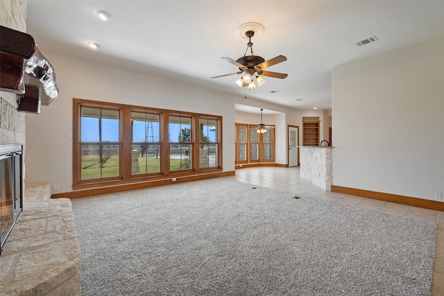 unfurnished living room featuring ceiling fan and light tile patterned flooring